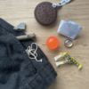 Biscuit chew necklace with school trousers and kids pocket contents