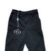 Large Fidgi-Flip fidget toy on wrist lanyard on school trousers