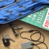 Grey taggle chew necklace on cord with handbag and contents