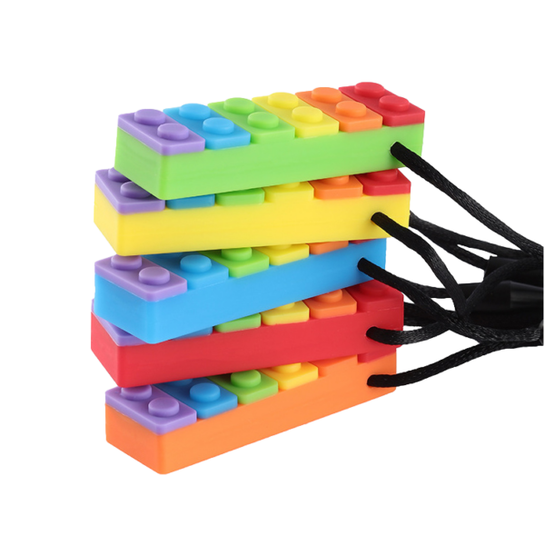 Stack of Rainbow brick sensory chew necklaces in green, yellow, blue, red and orange on black cord, all in a stack. On white background.