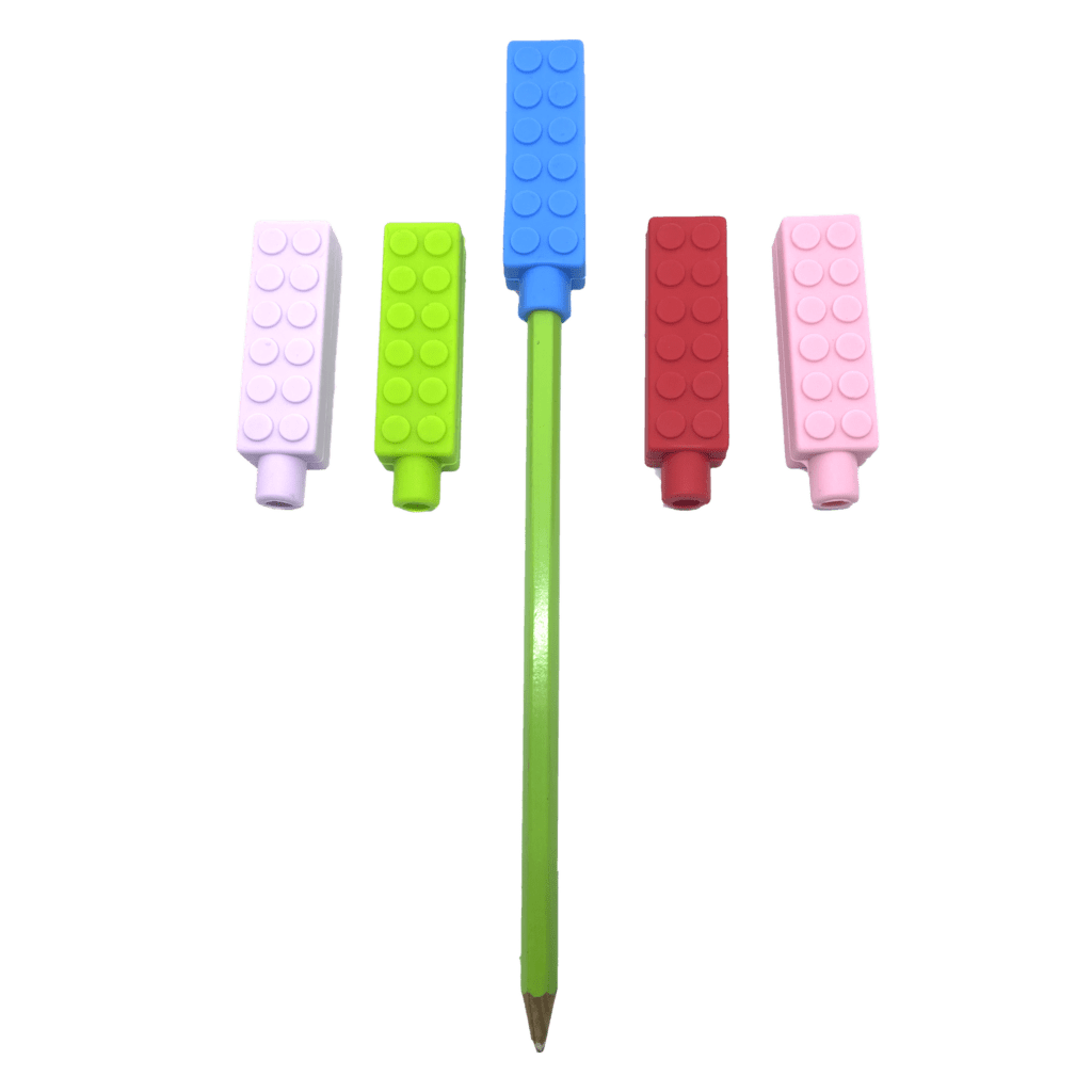 5 chewy brick pencil toppers in red, blue, pink, purple and green, one is on a pencil