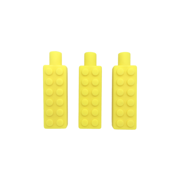 3 yellow chewy brick pencil toppers on white background