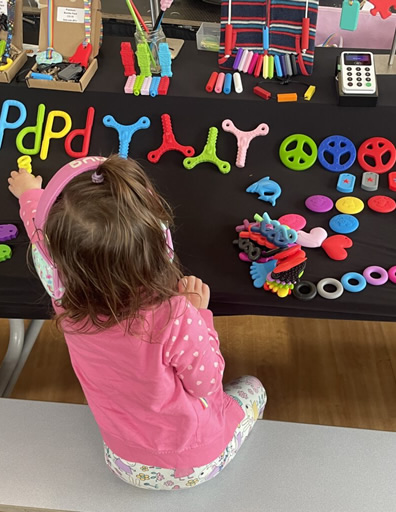 Photo of a young child playing with oojamabobs