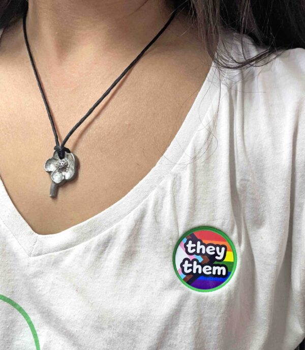 Pronoun pop badge with Pride flag backgrounds – they/them – from Sensory Oojamabobs