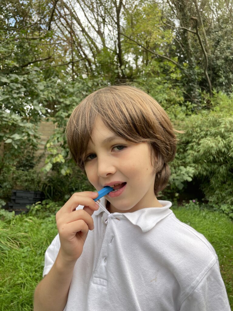 Model with zip chew on school polo top